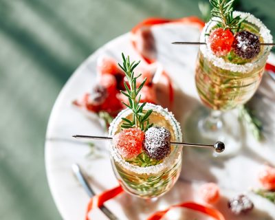 Christmas cocktail with sparkling wine, rosemary and cherry. Winter holidays champagne drink. Christmas cocktail with sparkling wine, rosemary and cherry. Winter holidays champagne drink.