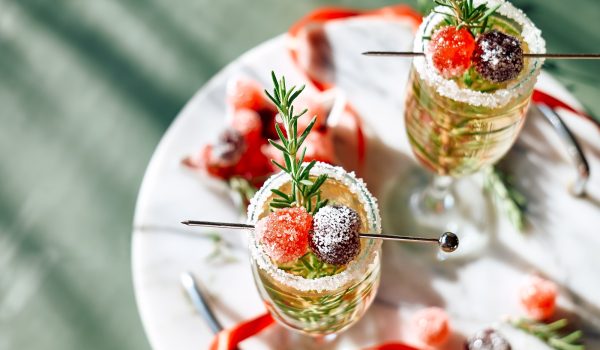 Christmas cocktail with sparkling wine, rosemary and cherry. Winter holidays champagne drink. Christmas cocktail with sparkling wine, rosemary and cherry. Winter holidays champagne drink.